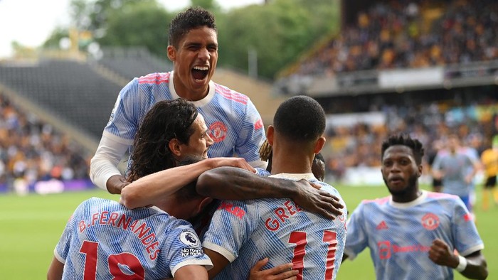 WOLVERHAMPTON, ENGLAND - AUGUST 29: Mason Greenwood of Manchester United celebrates after scoring their sides first goal  with team mates Bruno Fernandes, Raphaël Varane and Edinson Cavani during the Premier League match between Wolverhampton Wanderers  and  Manchester United at Molineux on August 29, 2021 in Wolverhampton, England. (Photo by Michael Regan/Getty Images)