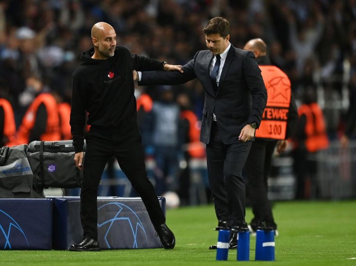 PARIS, FRANCE - SEPTEMBER 28: Pep Guardiola, Manager of Manchester City interacts with Mauricio Pochettino, Head Coach of Paris Saint-Germain after the UEFA Champions League group A match between Paris Saint-Germain and Manchester City at Parc des Princes on September 28, 2021 in Paris, France. (Photo by Shaun Botterill/Getty Images)