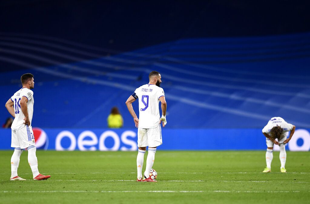 Real Madrid's Karim Benzema, center, Luka Jovic, left, and Luka Modric reacts after Sheriff's Sebastien Thill scoring his side's second goal during the Champions League group D soccer match between Real Madrid and Sheriff, Tiraspol at the Bernabeu stadium in Madrid, Spain, Tuesday, Sept. 28, 2021. (AP Photo/Jose Breton)