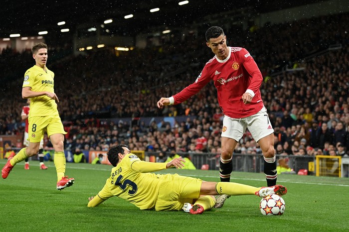 MANCHESTER, ENGLAND - SEPTEMBER 29: Cristiano Ronaldo of Manchester United is challenged by Daniel Parejo of Villarreal CF during the UEFA Champions League group F match between Manchester United and Villarreal CF at Old Trafford on September 29, 2021 in Manchester, England. (Photo by Michael Regan/Getty Images)