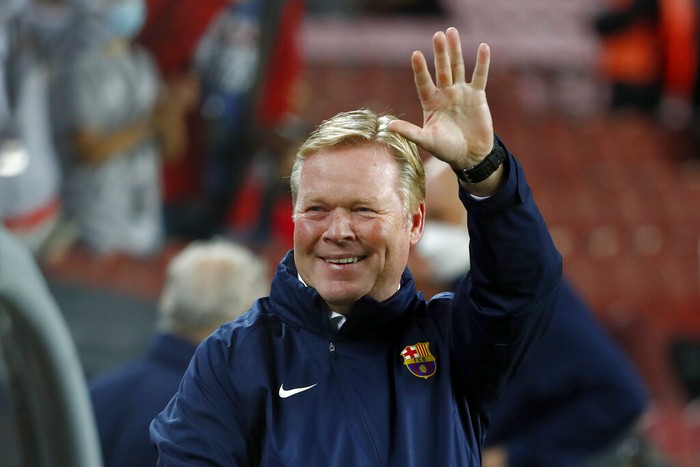 Barcelona's head coach Ronald Koeman waves during the Spanish La Liga soccer match between Barcelona and Granada, at the Camp Nou stadium in Barcelona, Spain, Monday, Sept. 20, 2021. (AP Photo/Joan Monfort)