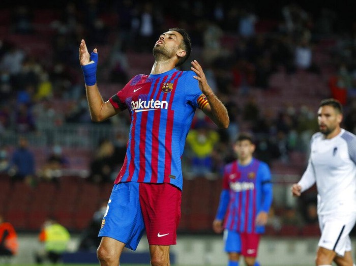 Barcelona's Sergio Busquets reacts after missing an opportunity to score during the Spanish La Liga soccer match between Barcelona and Granada, at the Camp Nou stadium in Barcelona, Spain, Monday, Sept. 20, 2021. (AP Photo/Joan Monfort)