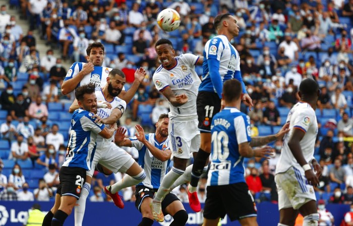 Real Madrid's Eder Militao, center left, and Espanyol's Raul de Tomas challenge for the ball during a Spanish La Liga soccer match between RCD Espanyol and Real Madrid at the Cornella-El Prat stadium in Barcelona, Spain, Sunday, Oct. 3, 2021. (AP Photo/Joan Monfort)