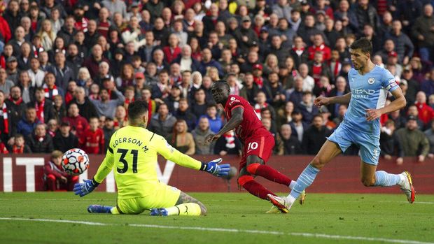 Manchester City's Kevin De Bruyne scores his side's second goal  during the English Premier League soccer match between Liverpool and Manchester City at Anfield, Liverpool, England, Sunday Oct. 3, 2021. (Peter Byrne/PA via AP)