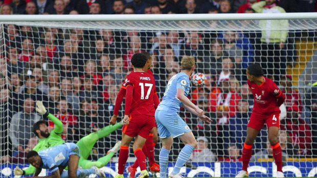 Manchester City's Kevin De Bruyne scores his side's second goal  during the English Premier League soccer match between Liverpool and Manchester City at Anfield, Liverpool, England, Sunday Oct. 3, 2021. (Peter Byrne/PA via AP)
