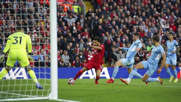 Liverpools Mohamed Salah scores his sides second goal  during the English Premier League soccer match between Liverpool and Manchester City at Anfield, Liverpool, England, Sunday Oct. 3, 2021. (Peter Byrne/PA via AP)