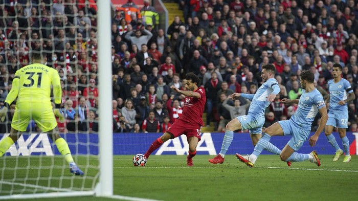 Liverpools Mohamed Salah scores his sides second goal  during the English Premier League soccer match between Liverpool and Manchester City at Anfield, Liverpool, England, Sunday Oct. 3, 2021. (Peter Byrne/PA via AP)