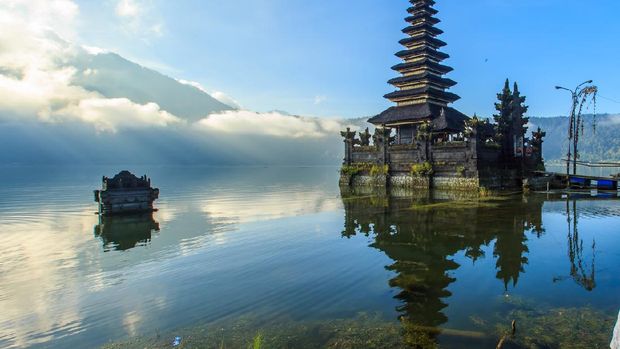 Pura Segara Ulun Batur di Kintamani, Bali Beautiful Lake Batur landscape overlooking serene and beautiful Mount Batur during blue sky cloudy day with abandoned sub-merge house at foreground.