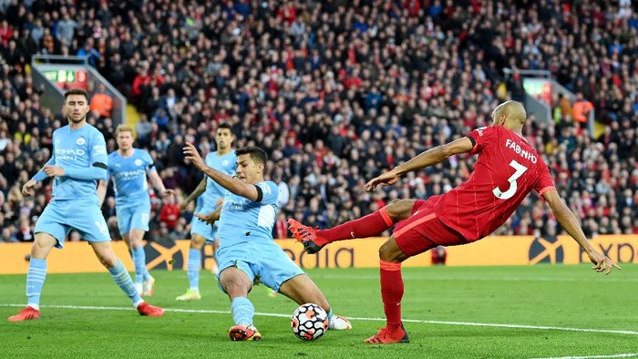 LIVERPOOL, ENGLAND - OCTOBER 03: Fabinho of Liverpool has a shot blocked by Rodrigo of Manchester City during the Premier League match between Liverpool and Manchester City at Anfield on October 03, 2021 in Liverpool, England. (Photo by Michael Regan/Getty Images)