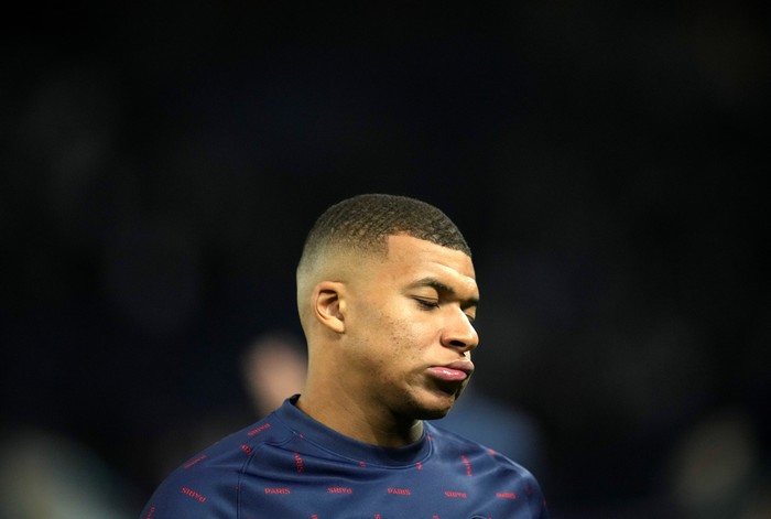 PSGs Kylian Mbappe grimaces during the warm-up before the Champions League Group A soccer match between Paris Saint-Germain and Manchester City at the Parc des Princes in Paris, Tuesday, Sept. 28, 2021. (AP Photo/Christophe Ena)