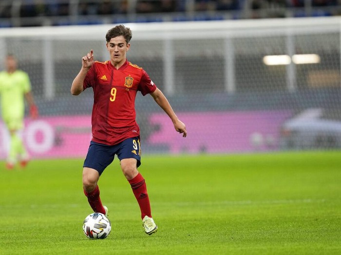 Spain's Gavi controls the ball during the UEFA Nations League semifinal soccer match between Italy and Spain at the San Siro stadium, in Milan, Italy, Wednesday, Oct. 6, 2021. (AP Photo/Antonio Calanni)