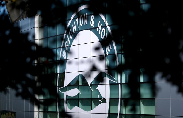 BRIGHTON, ENGLAND - SEPTEMBER 14: The Brighton and Hove Albion logo is seen through some tree branches prior to the Premier League match between Brighton & Hove Albion and Burnley FC at American Express Community Stadium on September 14, 2019 in Brighton, United Kingdom. (Photo by Dan Istitene/Getty Images)