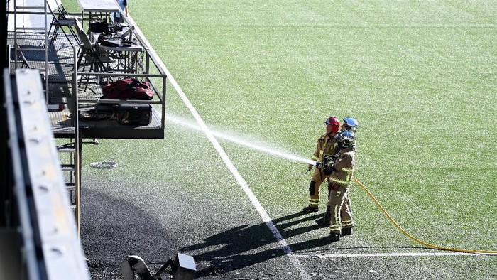 ANDORRA LA VELLA, ANDORRA - OCTOBER 08: Firefighters attend an incident at the stadium after the pitchside VAR monitor catches fire at Estadi Nacional on October 08, 2021 in Andorra la Vella, Andorra. (Photo by Michael Regan/Getty Images)