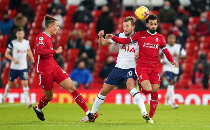 LIVERPOOL, ENGLAND - DECEMBER 16: Harry Kane of Tottenham Hotspur battles for possession with Mohamed Salah of Liverpool  during the Premier League match between Liverpool and Tottenham Hotspur at Anfield on December 16, 2020 in Liverpool, England. A limited number of fans (2000) are welcomed back to stadiums to watch elite football across England. This was following easing of restrictions on spectators in tiers one and two areas only. (Photo by Jon Super - Pool/Getty Images)