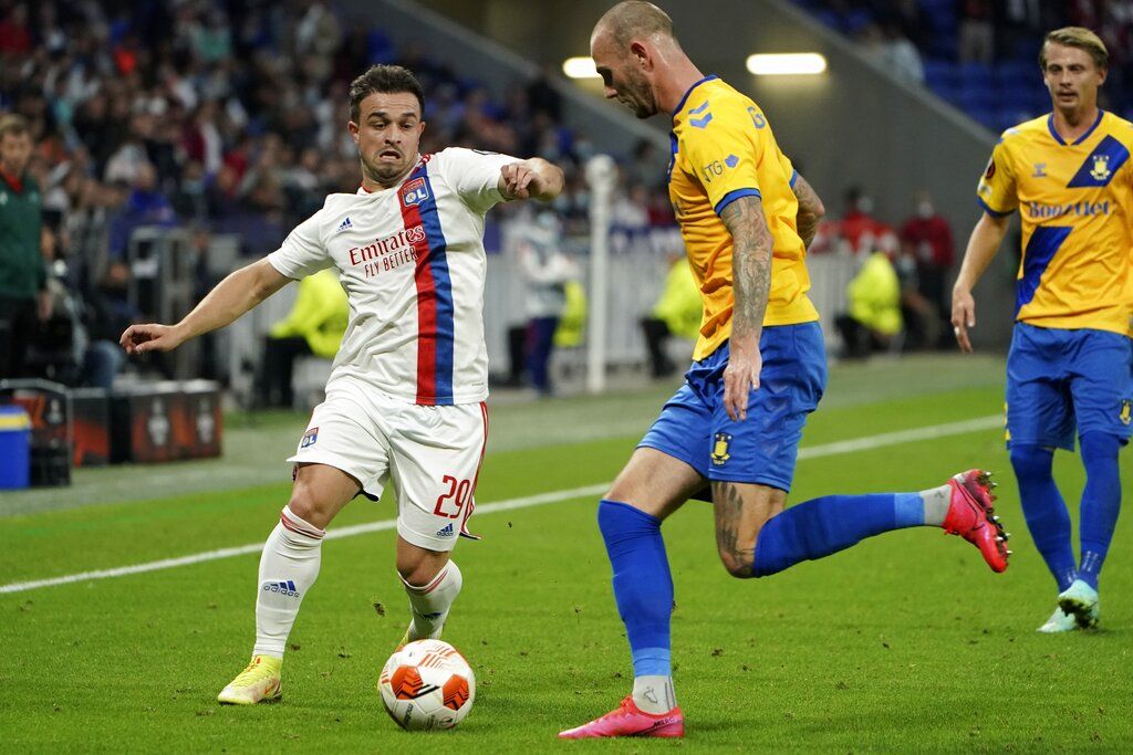 Lyon's Xherdan Shaqiri, left, and Brondby's Jens Martin Gammelby go for the ball during the Europa League Group A match between Lyon and Brondby at the Groupama stadium in Lyon, France, Thursday, Sept. 30, 2021. (AP Photo/Laurent Cipriani)