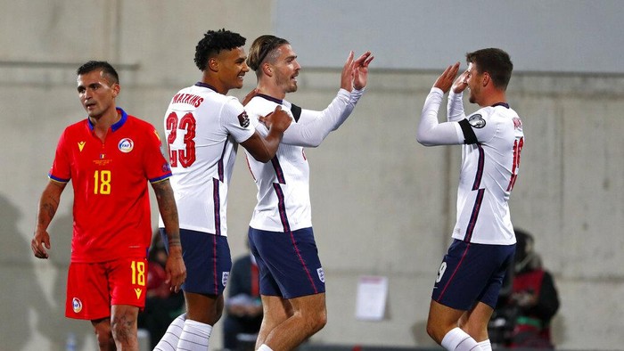 Englands Jack Grealish, center, celebrates after scoring his sides fifth goal during the World Cup 2022 group I qualifying soccer match between Andorra and England at the National Stadium in Andorra la Vella, Saturday, Oct. 9, 2021. (AP Photo/Joan Monfort)