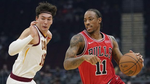 Chicago Bulls' DeMar DeRozan (11) drives against Cleveland Cavaliers' Cedi Osman (16) in the first half of an NBA basketball preseason game, Sunday, Oct. 10, 2021, in Cleveland. (AP Photo/Tony Dejak)