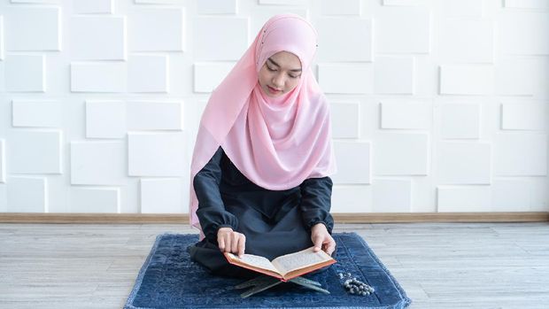 Young beautiful Muslim Woman Praying In Mosque.