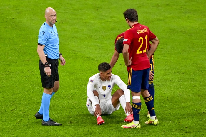 Frances Raphael Varane sits on the pitch after an injury during the UEFA Nations League final soccer match between Spain and France at the San Siro stadium, in Milan, Italy, Sunday, Oct. 10, 2021. (Miguel Medina/Pool Photo via AP)