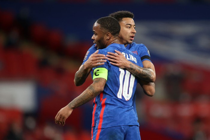 LONDON, ENGLAND - MARCH 25: Raheem Sterling of England celebrates with teammate Jesse Lingard after scoring their teams third goal during the FIFA World Cup 2022 Qatar qualifying match between England and San Marino at Wembley Stadium on March 25, 2021 in London, England. Sporting stadiums around the UK remain under strict restrictions due to the Coronavirus Pandemic as Government social distancing laws prohibit fans inside venues resulting in games being played behind closed doors.  (Photo by Carl Recine - Pool/Getty Images)