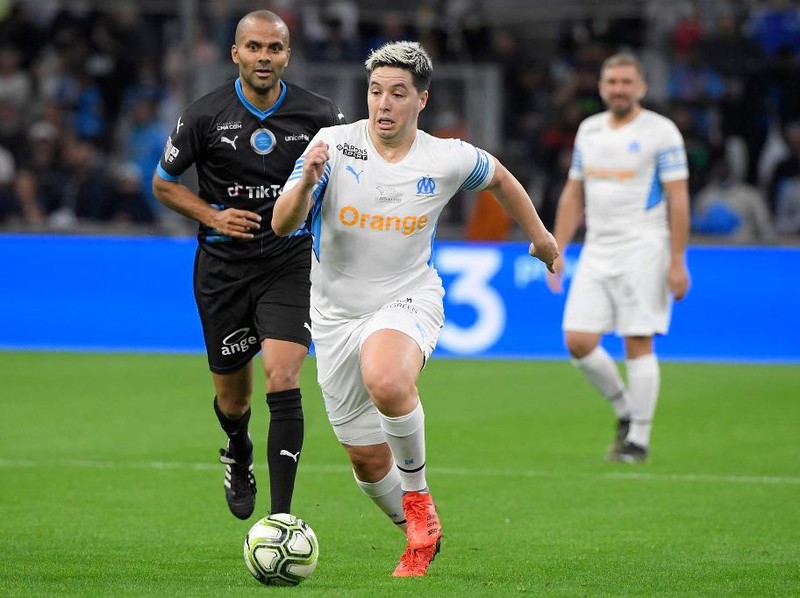 French former player Samir Nasri (R) vies with French former basket ball player Tony Parker (L) during the charity 