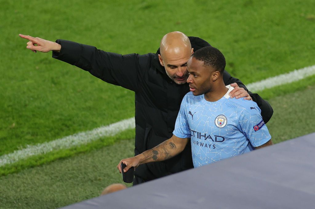 DORTMUND, GERMANY - APRIL 14: Pep Guardiola, Manager of Manchester City speaks with Substitute, Raheem Sterling of Manchester City during the UEFA Champions League Quarter Final Second Leg match between Borussia Dortmund and Manchester City at Signal Iduna Park on April 14, 2021 in Dortmund, Germany. Sporting stadiums around Germany remain under strict restrictions due to the Coronavirus Pandemic as Government social distancing laws prohibit fans inside venues resulting in games being played behind closed doors.  (Photo by Friedemann Vogel - Pool/Getty Images)