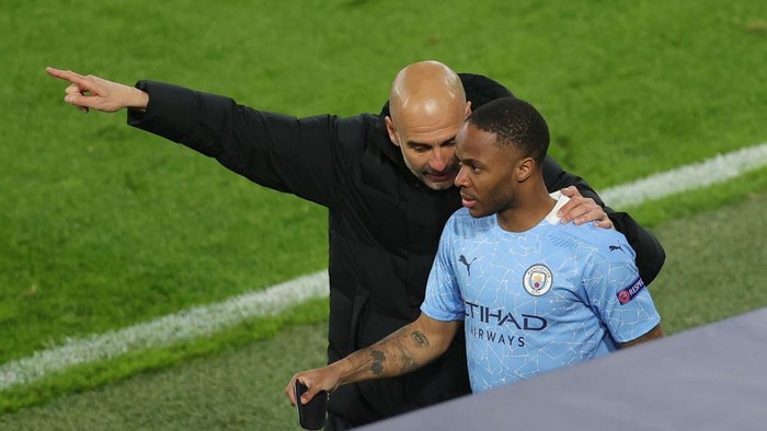 DORTMUND, GERMANY - APRIL 14: Pep Guardiola, Manager of Manchester City speaks with Substitute, Raheem Sterling of Manchester City during the UEFA Champions League Quarter Final Second Leg match between Borussia Dortmund and Manchester City at Signal Iduna Park on April 14, 2021 in Dortmund, Germany. Sporting stadiums around Germany remain under strict restrictions due to the Coronavirus Pandemic as Government social distancing laws prohibit fans inside venues resulting in games being played behind closed doors.  (Photo by Friedemann Vogel - Pool/Getty Images)