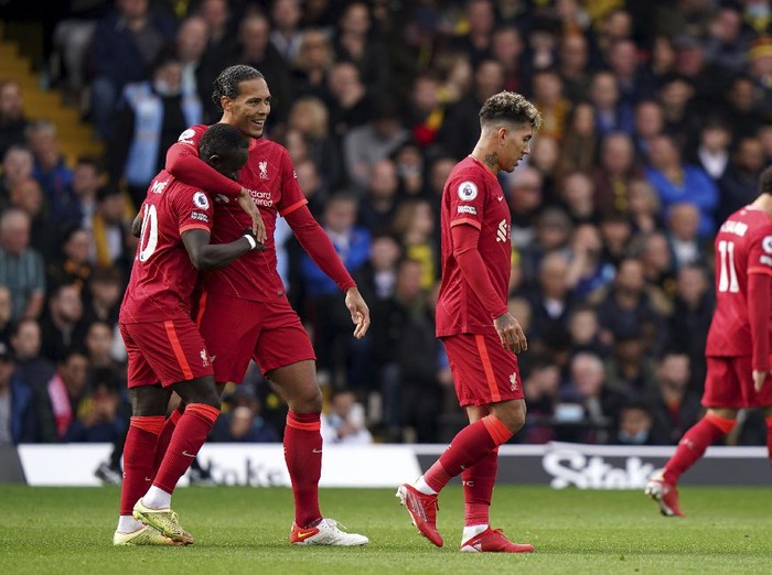Liverpools Sadio Mane, left, celebrates scoring their sides first goal of the game during the English Premier League soccer match between Watford and Liverpool at Vicarage Road, Watford, England, Saturday, Oct. 16, 2021. (Tess Derry/PA via AP)