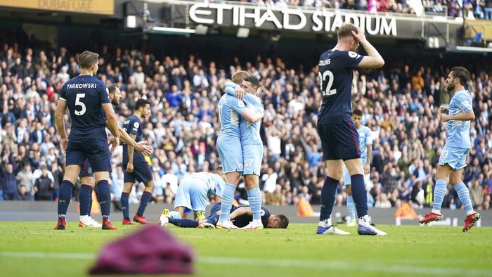 Manchester Citys Kevin De Bruyne, center left, celebrates with his teammate Phil Foden after scoring his sides second goal during the English Premier League soccer match between Manchester City and Burnley at Etihad stadium in Manchester, England, Saturday, Oct. 16, 2021. (AP Photo/Jon Super)