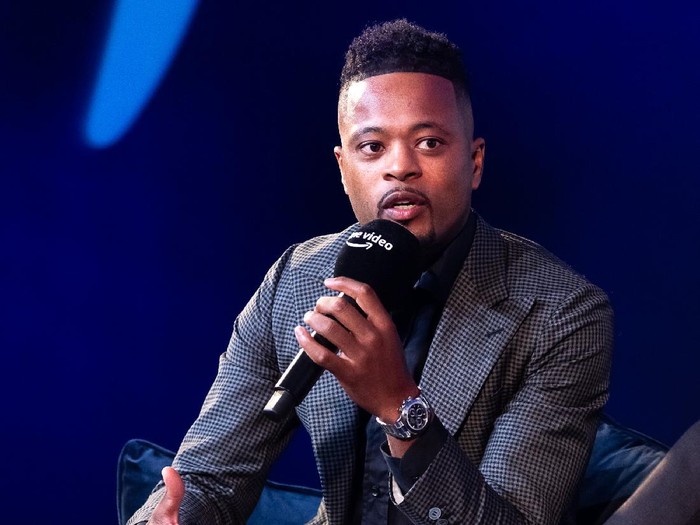 LONDON, ENGLAND - OCTOBER 12: Patrice Evra speaking with Gabby Logan on stage at the Prime Video Presents Sport event at Pan Pacific on October 12, 2021 in London, England.  At the event a series of announcements were revealed, including the Amazon Original documentary on the life and career of Wayne Rooney and Lioness: The Nicola Adams Story.  (Photo by Tim P. Whitby/Getty Images for Amazon Prime)