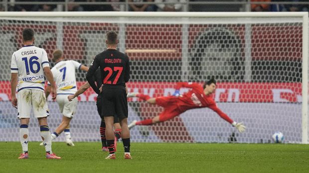 Verona's Antonin Barak, second left, scores his side's second goal from the penalty spot during the Serie A soccer match between AC Milan and Verona at the San Siro stadium, in Milan, Italy, Saturday, Oct. 16, 2021. (AP Photo/Antonio Calanni)