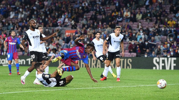BARCELONA, SPAIN - OCTOBER 17: Ansu Fati of FC Barcelona is fouled by Jose Luis Gaya of Valencia CF which leads to a FC Barcelona penalty during the LaLiga Santander match between FC Barcelona and Valencia CF at Camp Nou on October 17, 2021 in Barcelona, Spain. (Photo by Alex Caparros/Getty Images)