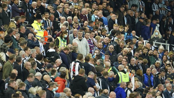 Newcastle United vs Tottenham Hotspur Fans stand around a person with a possible medical problem in the crowd during an English Premier League soccer match between Newcastle and Tottenham Hotspur at St. James Park in Newcastle, England, Sunday Oct. 17, 2021. (AP Photo/Jon Super)