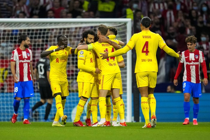 Liverpool players celebrate after scoring the opening goal during the Champions League Group B soccer match between Atletico Madrid and Liverpool at Wanda Metropolitano stadium in Madrid, Spain, Tuesday, Oct. 19, 2021. (AP Photo/Manu Fernandez)