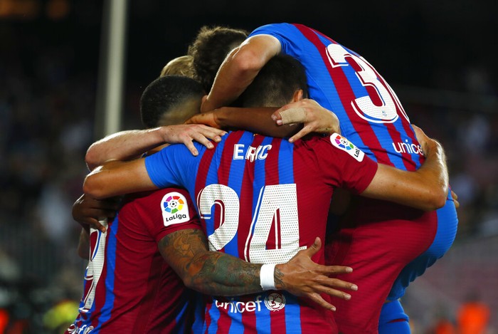Barcelona players celebrate after Barcelona's Memphis Depay scored his side's second goal during the Spanish La Liga soccer match between FC Barcelona and Valencia at the Camp Nou stadium in Barcelona, Spain, Sunday, Oct. 17, 2021. (AP Photo/Joan Monfort)