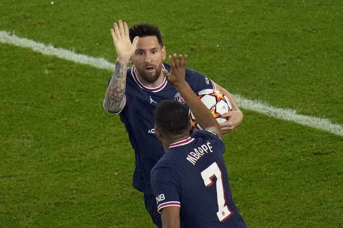 PSGs Lionel Messi celebrates with PSGs Kylian Mbappe after scoring his sides second goal during his Champions League soccer match between Paris Saint Germain and RB Leipzig at the Parc des Princes stadium in Paris, Tuesday, Oct. 19, 2021. (AP Photo/Christophe Ena)