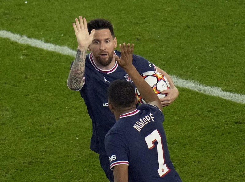 PSG's Lionel Messi celebrates with PSG's Kylian Mbappe after scoring his side's second goal during his Champions League soccer match between Paris Saint Germain and RB Leipzig at the Parc des Princes stadium in Paris, Tuesday, Oct. 19, 2021. (AP Photo/Christophe Ena)