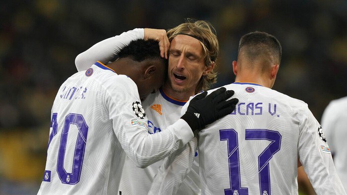 Real Madrids Vinicius Junior, left, celebrates with Luka Modric and Lucas Vazquez after scoring his sides third goal during the Champions League group D soccer match between Shakhtar Donetsk and Real Madrid at the Olympiyskiy stadium in Kyiv, Ukraine, Tuesday, Oct. 19, 2021. (AP Photo/Efrem Lukatsky)