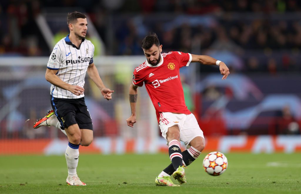 MANCHESTER, ENGLAND - OCTOBER 20: Bruno Fernandes of Manchester United passes the ball whilst under pressure from Remo Freuler of Atalanta during the UEFA Champions League group F match between Manchester United and Atalanta at Old Trafford on October 20, 2021 in Manchester, England. (Photo by Naomi Baker/Getty Images)
