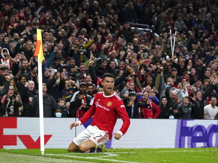 Manchester United's Cristiano Ronaldo celebrates scoring their side's third goal of the game during the Champions League Group F soccer match between Manchester United and Atalanta at Old Trafford, Manchester, England, Wednesday, Oct. 20, 2021. (Martin Rickett/PA via AP)