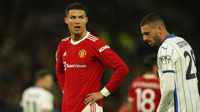 Manchester Uniteds Cristiano Ronaldo stands on pitch after Atalantas Merih Demiral, right, scored his sides second goal during the Champions League Group F soccer match between Manchester United and Atalanta at Old Trafford, Manchester, England, Wednesday, Oct. 20, 2021. (AP Photo/Dave Thompson)