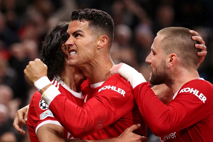 MANCHESTER, ENGLAND - OCTOBER 20: Cristiano Ronaldo of Manchester United celebrates with teammates Luke Shaw and Edinson Cavani after scoring their sides third goal during the UEFA Champions League group F match between Manchester United and Atalanta at Old Trafford on October 20, 2021 in Manchester, England. (Photo by Naomi Baker/Getty Images)