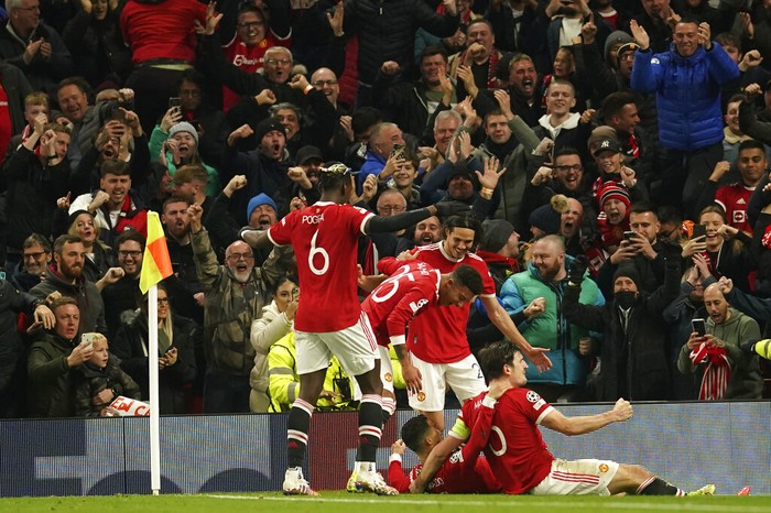 Manchester Uniteds Cristiano Ronaldo celebrates with teammates after scoring his sides third goal during the Champions League Group F soccer match between Manchester United and Atalanta at Old Trafford, Manchester, England, Wednesday, Oct. 20, 2021. (AP Photo/Dave Thompson)