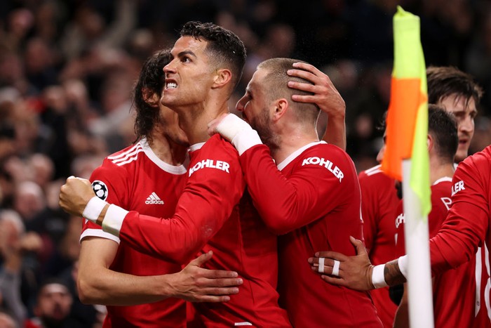 MANCHESTER, ENGLAND - OCTOBER 20: Cristiano Ronaldo of Manchester United celebrates with teammates Luke Shaw and Edinson Cavani after scoring their sides third goal during the UEFA Champions League group F match between Manchester United and Atalanta at Old Trafford on October 20, 2021 in Manchester, England. (Photo by Naomi Baker/Getty Images)