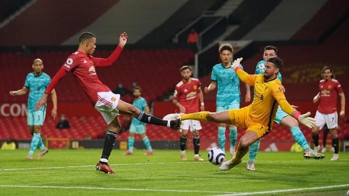 MANCHESTER, ENGLAND - MAY 13: Mason Greenwood of Manchester United has a shot saved by Alisson of Liverpool during the Premier League match between Manchester United and Liverpool at Old Trafford on May 13, 2021 in Manchester, England. Sporting stadiums around the UK remain under strict restrictions due to the Coronavirus Pandemic as Government social distancing laws prohibit fans inside venues resulting in games being played behind closed doors. (Photo by Dave Thompson - Pool/Getty Images)