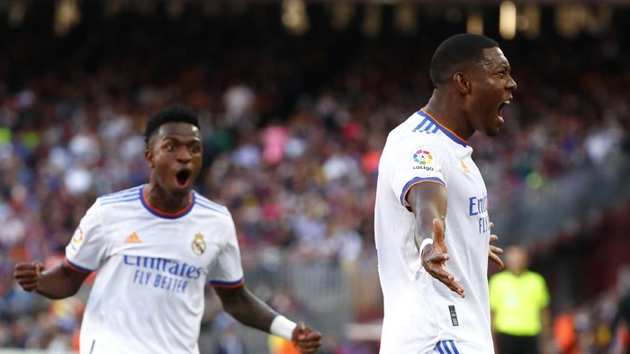 Real Madrids David Alaba, right, celebrates with Real Madrids Vinicius Junior after scoring his sides first goal during the Spanish La Liga soccer match between FC Barcelona and Real Madrid at the Camp Nou stadium in Barcelona, Spain, Sunday, Oct. 24, 2021. (AP Photo/Joan Monfort)