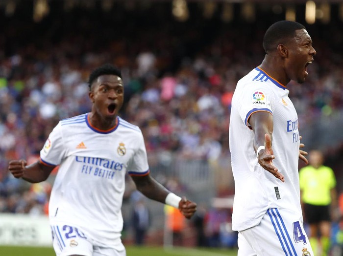 Real Madrid's David Alaba, right, celebrates with Real Madrid's Vinicius Junior after scoring his sides first goal during the Spanish La Liga soccer match between FC Barcelona and Real Madrid at the Camp Nou stadium in Barcelona, Spain, Sunday, Oct. 24, 2021. (AP Photo/Joan Monfort)