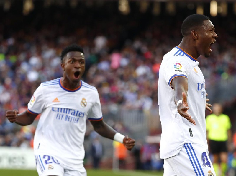 Real Madrid's David Alaba, right, celebrates with Real Madrid's Vinicius Junior after scoring his sides first goal during the Spanish La Liga soccer match between FC Barcelona and Real Madrid at the Camp Nou stadium in Barcelona, Spain, Sunday, Oct. 24, 2021. (AP Photo/Joan Monfort)