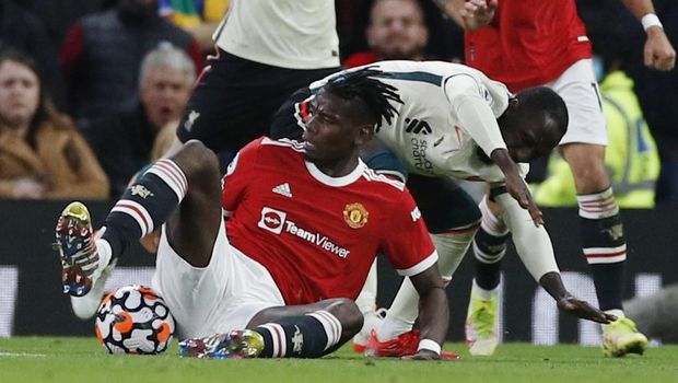 Soccer Football - Premier League - Manchester United v Liverpool - Old Trafford, Manchester, Britain - October 24, 2021 Manchester United's Paul Pogba fouls Liverpool's Naby Keita before being sent off after a VAR review REUTERS/Phil Noble EDITORIAL USE ONLY. No use with unauthorized audio, video, data, fixture lists, club/league logos or 'live' services. Online in-match use limited to 75 images, no video emulation. No use in betting, games or single club /league/player publications. Please contact your account representative for further details.