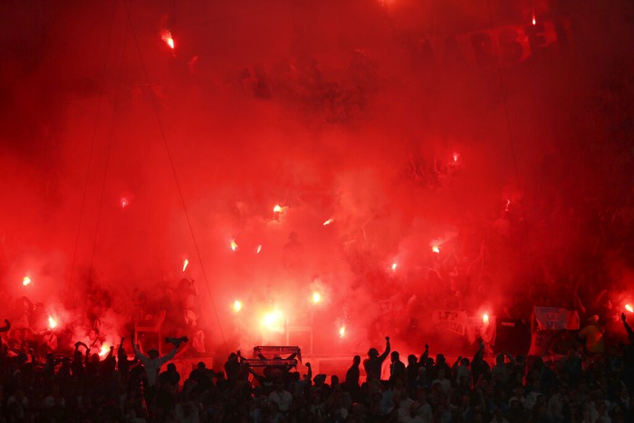 Marseille vs PSG Marseille fans hold flares as they fill the stands during the French League One soccer match between Marseille and Paris Saint-Germain in Marseille, France, Sunday, Oct. 24, 2021. (AP Photo/Daniel Cole)